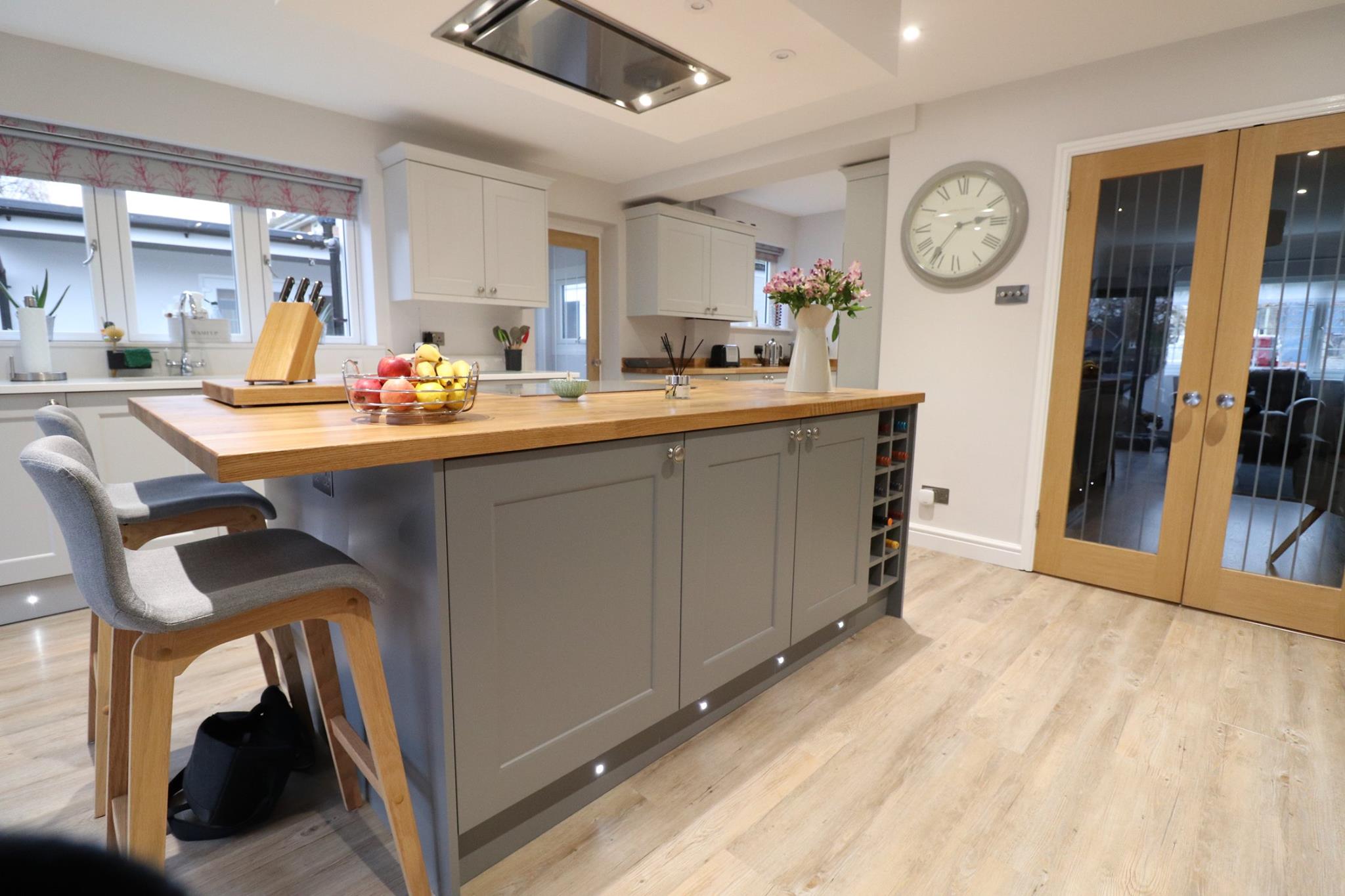 Painted shaker kitchen with sage grey island, oak worktop and integrated wine rack — Inner Peace Interiors, Camberley